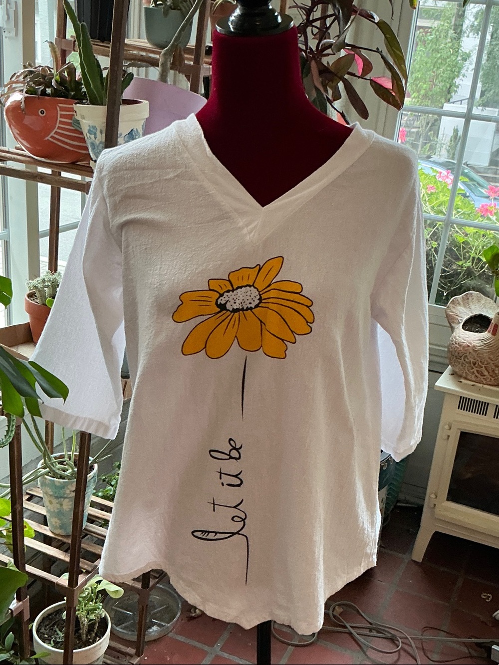 White V-Neck Women's Top with Yellow Daisy Graphic LET IT BE under the flower